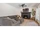 Cozy living room features a comfortable sectional sofa, fireplace, and hardwood floors at 5833 Dahlberg Dr, Raleigh, NC 27603