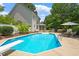 Large pool with diving board, lounge chairs and mature landscaping at 5833 Dahlberg Dr, Raleigh, NC 27603