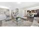 Bright living room featuring elegant furnishings and an open floor plan leading to the kitchen at 59 Curling Creek Dr # I285, Clayton, NC 27527