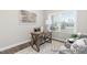 Cozy home office with a wooden desk, comfortable chairs, and natural light from a window at 59 Curling Creek Dr # I285, Clayton, NC 27527