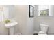 Well-lit powder room featuring a pedestal sink, modern fixtures, and neutral decor at 59 Curling Creek Dr # I285, Clayton, NC 27527
