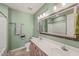 Well-lit bathroom featuring double sinks, tile flooring, and plenty of counter space at 6051 Epping Forest Dr, Raleigh, NC 27613