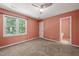 Bedroom featuring carpet, window, and doorway to another room at 6051 Epping Forest Dr, Raleigh, NC 27613