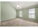 Comfortable bedroom with neutral carpet, vaulted ceiling, and natural light from two windows at 6051 Epping Forest Dr, Raleigh, NC 27613