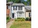 Charming townhouse with black shutters, a bay window, and manicured front lawn at 6051 Epping Forest Dr, Raleigh, NC 27613