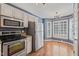 Bright kitchen featuring stainless steel appliances and a cozy breakfast nook area at 6051 Epping Forest Dr, Raleigh, NC 27613