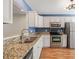 Updated kitchen with stainless steel appliances, white cabinets, and granite countertops at 6051 Epping Forest Dr, Raleigh, NC 27613