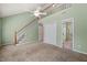 Spacious living area with staircase, ceiling fan, carpet, and access to another room at 6051 Epping Forest Dr, Raleigh, NC 27613