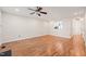 Open living room with wood floors, a ceiling fan, and a pass-through to the kitchen at 6051 Epping Forest Dr, Raleigh, NC 27613