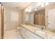 Bathroom features double sink vanity with granite counters and a shower with curtains at 6205 Remington Lake Dr, Raleigh, NC 27616