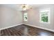 Bedroom features wood floors, neutral paint, and two bright windows overlooking the yard at 6205 Remington Lake Dr, Raleigh, NC 27616