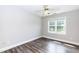 Bedroom features wood floors, neutral walls, and a bright window overlooking the yard at 6205 Remington Lake Dr, Raleigh, NC 27616