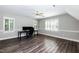 Bright bonus room with hardwood floors, plantation shutters, and modern ceiling fan at 6205 Remington Lake Dr, Raleigh, NC 27616
