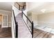Grand foyer with staircase featuring a black and white railing, and hardwood flooring at 6205 Remington Lake Dr, Raleigh, NC 27616