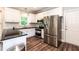 Modern kitchen with stainless steel appliances, dark countertops, and white cabinetry at 6205 Remington Lake Dr, Raleigh, NC 27616