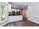 Well-lit kitchen with stainless steel appliances, white cabinetry, and sleek dark countertops at 6205 Remington Lake Dr, Raleigh, NC 27616