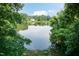 Scenic lake view framed by lush greenery, offering a tranquil outdoor setting at 6205 Remington Lake Dr, Raleigh, NC 27616