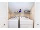 Laundry room features modern washer and dryer with storage shelf above the appliances at 6205 Remington Lake Dr, Raleigh, NC 27616