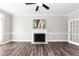 Bright living room with a fireplace, ceiling fan and white trim at 6205 Remington Lake Dr, Raleigh, NC 27616