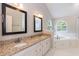 Double sink vanity with granite counters is featured in the bright main bathroom at 6205 Remington Lake Dr, Raleigh, NC 27616