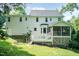 Back of house features deck, screened porch, and well-maintained lawn at 6205 Remington Lake Dr, Raleigh, NC 27616