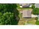 Aerial view of a home with a well-manicured lawn, mature trees, and a covered patio in a quiet neighborhood at 642 Collington Dr, Mebane, NC 27302