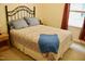 Comfortable bedroom with iron frame bed, patterned bedding, and natural light from the window at 642 Collington Dr, Mebane, NC 27302