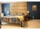 Bedroom showcasing a wood-paneled accent wall and soft, neutral-toned bedding at 642 Collington Dr, Mebane, NC 27302