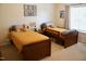 Bedroom featuring two twin beds with yellow bedding and neutral walls with floral artwork at 642 Collington Dr, Mebane, NC 27302