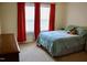 Bedroom featuring red curtains and a bed with aqua bedding and plush toys at 642 Collington Dr, Mebane, NC 27302