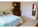 Bedroom with blue bedding, a desk with bookcase, and a white closet at 642 Collington Dr, Mebane, NC 27302