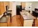Bright, modern kitchen featuring a large island, a pantry, and wood floors at 642 Collington Dr, Mebane, NC 27302