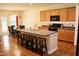 Spacious kitchen featuring a central island with seating, wood cabinets, and modern appliances at 642 Collington Dr, Mebane, NC 27302