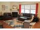 Cozy living room with a fireplace, plush leather seating, and a colorful decorative rug at 642 Collington Dr, Mebane, NC 27302