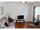 Cozy living room with comfortable seating, wood floors, a media center, and bright window at 642 Collington Dr, Mebane, NC 27302