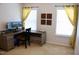 Office space with a gray desk, dual monitors, yellow curtains, and natural light at 642 Collington Dr, Mebane, NC 27302
