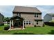 Back of house with covered patio and green lawn at 642 Collington Dr, Mebane, NC 27302