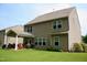 Rear exterior view showing a covered porch and large windows at 642 Collington Dr, Mebane, NC 27302
