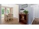 Elegant dining area adjacent to living area, hardwood flooring, and natural light from the outdoor view at 65 Alcock Ln, Youngsville, NC 27596