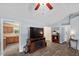 Bright living area with modern entertainment center, hardwood flooring, and easy access to kitchen at 65 Alcock Ln, Youngsville, NC 27596