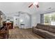 Spacious living room with hardwood floors, ceiling fan, and a cozy seating area with a sofa and side table at 65 Alcock Ln, Youngsville, NC 27596