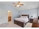 Well-lit main bedroom with neutral walls, a ceiling fan, and carpeted floors at 65 Alcock Ln, Youngsville, NC 27596