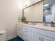 Bright bathroom with double vanity, white cabinetry, and a decorative framed mirror at 67 Blue Spruce Cir, Clayton, NC 27527