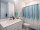 Bathroom featuring single vanity, white cabinetry and a shower with blue curtain at 67 Blue Spruce Cir, Clayton, NC 27527