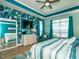 Beautiful primary bedroom with tray ceiling, large mirror and an accent wall featuring tropical wallpaper at 67 Blue Spruce Cir, Clayton, NC 27527