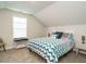 Upstairs bedroom featuring a full bed, carpet flooring, and natural light at 67 Blue Spruce Cir, Clayton, NC 27527