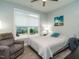 Bedroom with large window, gray accent chair and carpet, and natural light at 67 Blue Spruce Cir, Clayton, NC 27527