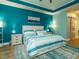 Comfortable bedroom featuring a king bed, blue accent wall, and bright natural lighting at 67 Blue Spruce Cir, Clayton, NC 27527