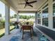 Inviting covered patio with an outdoor dining set, ceiling fan, and view of the backyard at 67 Blue Spruce Cir, Clayton, NC 27527