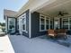 View of covered patio with outdoor dining set and exterior access at 67 Blue Spruce Cir, Clayton, NC 27527